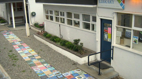 Exterior view of the Boston Bar Library featuring a sidewalk adorned with bright, colorful tiles, enhancing the setting.
