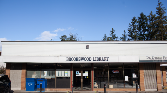  Brookswood Library's exterior featuring the building's entrance and the sign prominently displayed.
