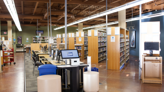 A view of Murrayville Library's interior showcasing a computer surrounded by books and study spaces.