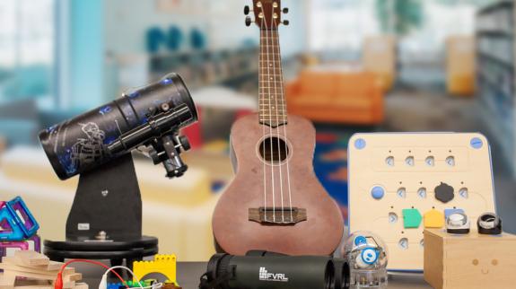 A table displaying a ukulele, telescope, and assorted playground items, showcasing a blend of hobbies and interests.