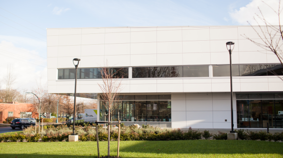 A large modern building, the Terry Fox Library, captured in an exterior photo highlighting its design and setting.