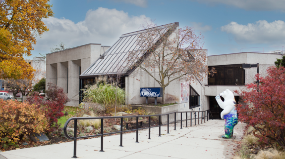 Exterior view of the white rock library, showcasing its clean lines and bright facade against a clear sky.