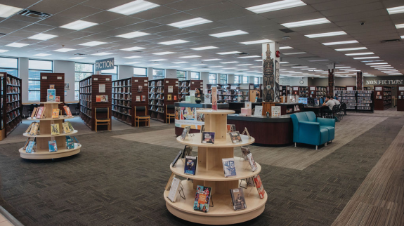 Interior of Mission Library featuring shelves of books and comfortable chairs for reading and studying.