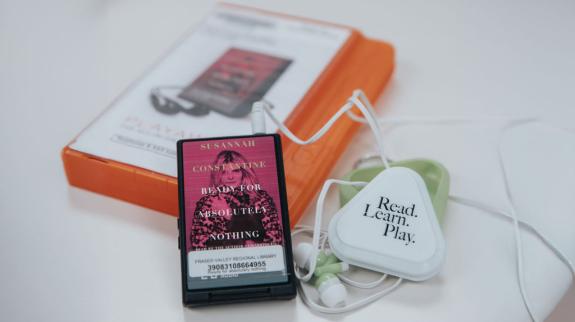 An FVRL audiobook in Playaway format. A plastic case and FVRL-branded earphones are visible.