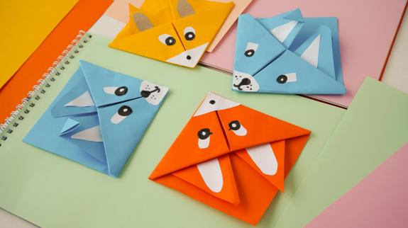 Colorful origami paper bookmarks corners in the form of animals.