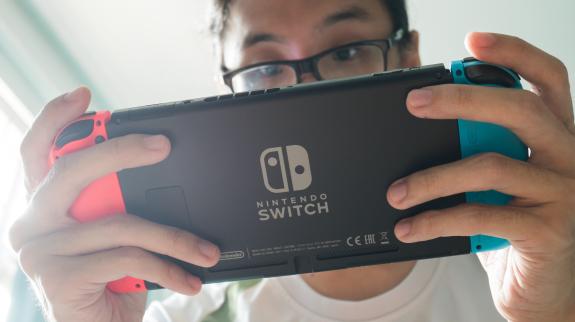 A man playing Nintendo Switch.
