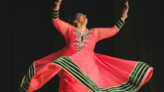 Karima Essa holding a dance pose.