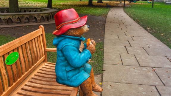 Paddington Bear on a park bench near the Minster in York, UK.