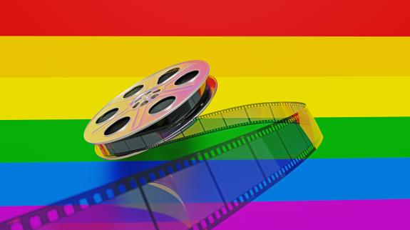 Film reel sitting on LGBTQIA Pride Flag.