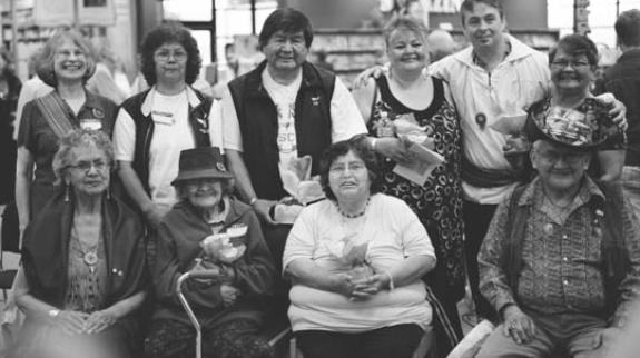 9 local Indigenous Elders posing for a picture with the Totem artist Pascal Pelletier 