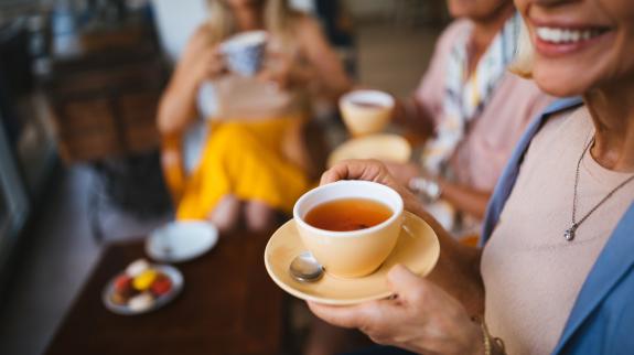 Close-up of group of senior women relaxing and drinking tea together and socializing.