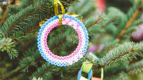 Handmade fuse beads wreath decoration on Christmas tree. 