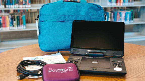 Portable blu-ray player with carrying case and accessories.