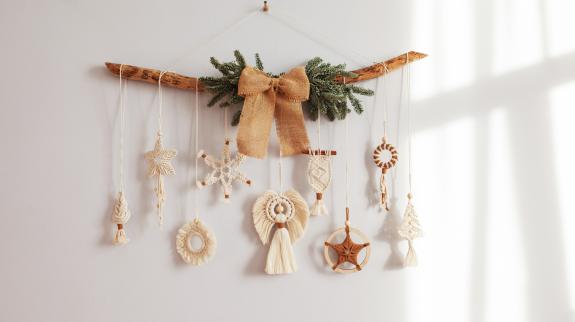 Macrame Christmas snowflake and decorative elements on wooden stick. 
