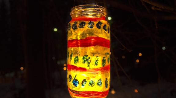 Hand decorated and painted holiday mason jar lantern.