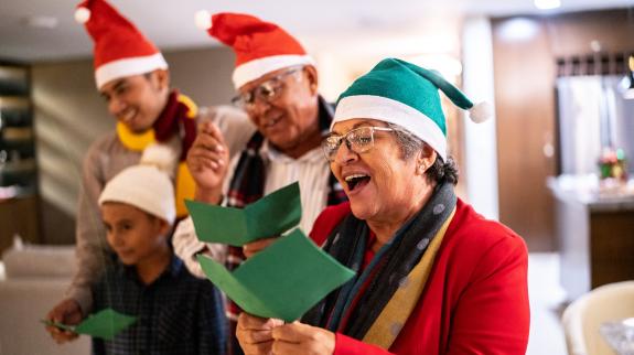 Family singing Christmas carols together.
