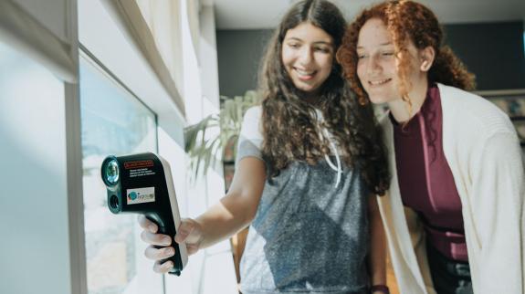Two teenage girls use a Thermal Leak Detector from the FVRL Playground collection.