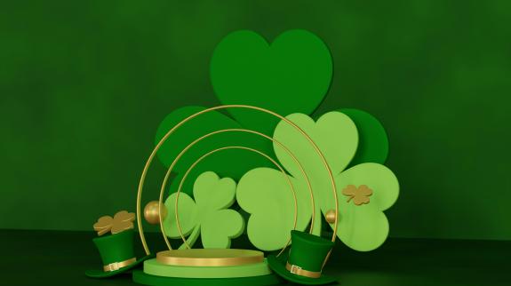 Green clovers on a gold and green platform with small green top hats.