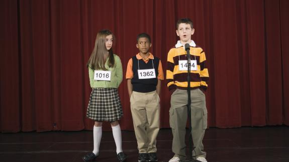 Spelling bee participants on stage.