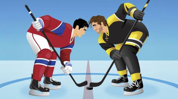 Two male hockey players face off on the ice rink.