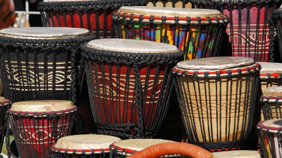 A variety of different coloured Djembe drums.