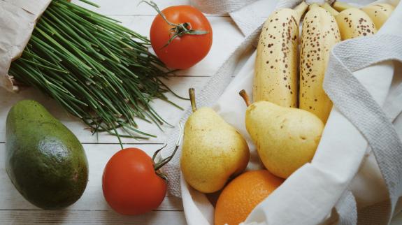 Bag of fruits and vegetables, pears, bananas, tomatoes, avocado, chives