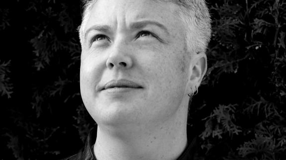 Black and white headshot of author Loghan Paylor.