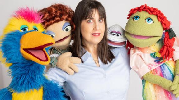 Kellie Haines with colourful puppets.