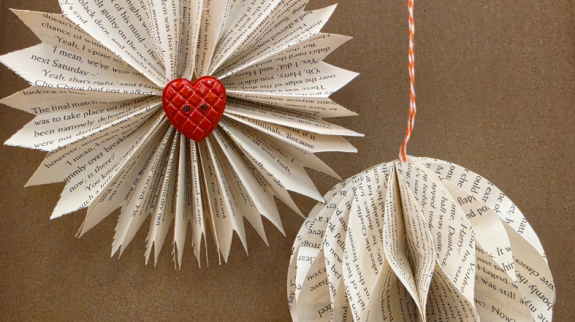 A pair of paper ornaments created using upcycled book pages.