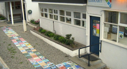  Exterior view of the Boston Bar Library featuring a sidewalk adorned with bright, colorful tiles, enhancing the setting.