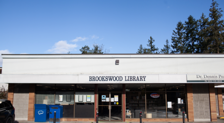 Brookswood Library's exterior featuring the building's entrance and the sign prominently displayed.
