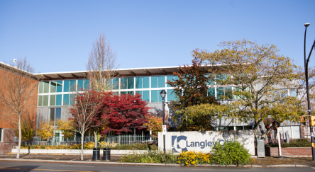 A large, window-filled building in the City of Langley, featuring the exterior of the library.