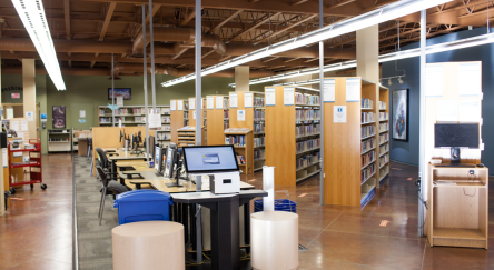 A view of Murrayville Library's interior showcasing a computer surrounded by books and study spaces.