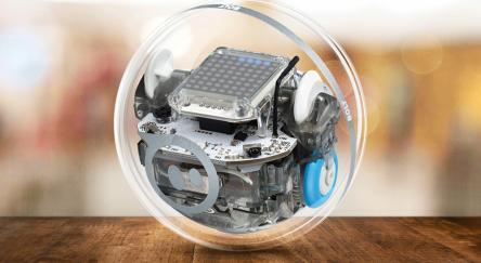 A Sphero Bolt encased within a transparent glass sphere, showcasing its intricate design and technology.