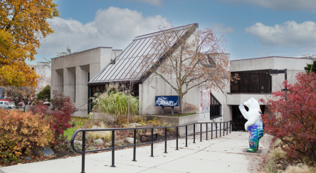 Exterior view of the white rock library, showcasing its clean lines and bright facade against a clear sky.