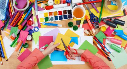 Child cut applique top view. Artwork workplace with creative accessories. Flat lay art tools for painting.