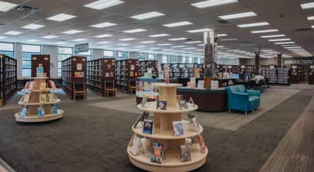 Interior of Mission Library featuring shelves of books and comfortable chairs for reading and studying.