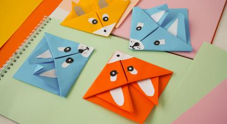 Colorful origami paper bookmarks corners in the form of animals.