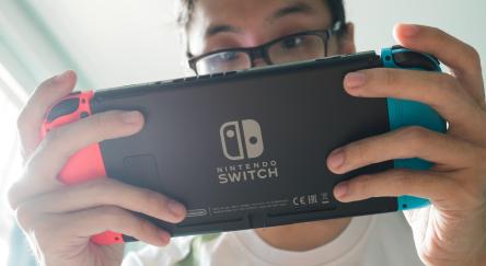 A man playing Nintendo Switch.