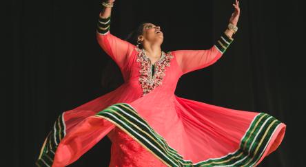 Karima Essa holding a dance pose.