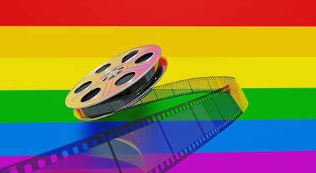 Film reel sitting on LGBTQIA Pride Flag.