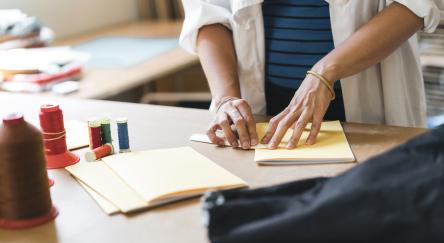 Young adult woman making a notebook. Japanese binding style.
