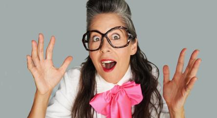 Dr. Professor with her hands in the air.