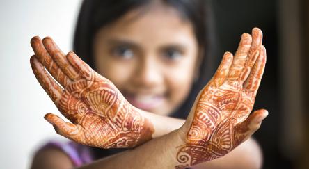 Little Girl shows off her henna tattoo also called Mehendi.