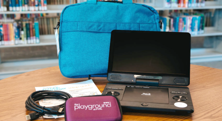 Portable blu-ray player with carrying case and accessories.