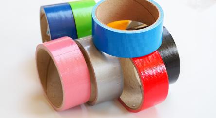 Rolls of colourful duct tape isolated on white background. 