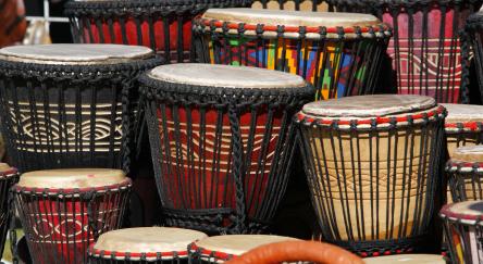 A variety of different coloured Djembe drums.