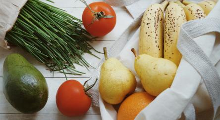 Bag of fruits and vegetables, pears, bananas, tomatoes, avocado, chives