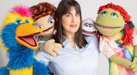 Kellie Haines with colourful puppets.