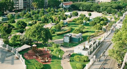 A landscape of a park and city.